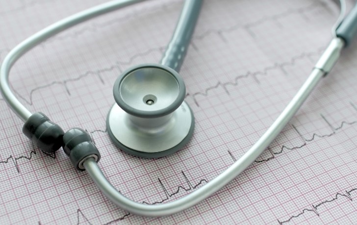 Close-up photo of a stethoscope on an ECG printout, symbolizing medical diagnostics